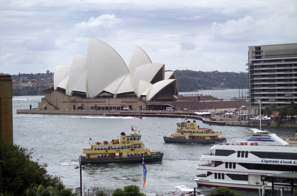 Long shot of Circular Quay with Captain Cook Cruise and Sydney Ferry in harbour, and the Opera House in background, Sydney | Photo Credit:Destination NSW; Sally Mayman