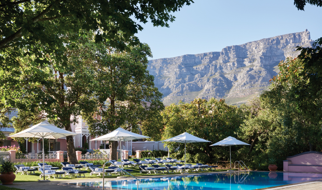 Image of the Belmond Nelson Hotel pool in the foreground with Table Mountain in the background