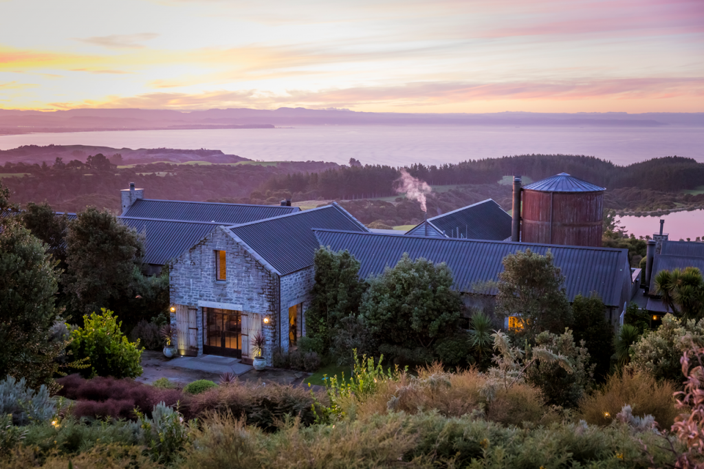 Cape Kidnappers lodge in the foreground with Hawke Bay in the background.