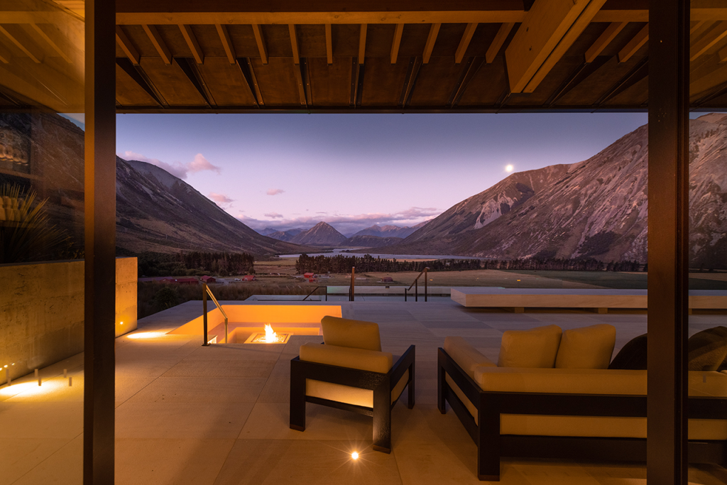 Image of Deck with fire pit and pool in foreground, sweeping views of mountains in the background.