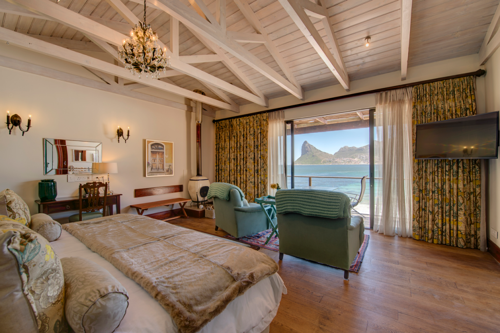 Image of the Antigua Island Suite at Tintswalo Atlantic with Hout Bay seen through the windows in the background.
